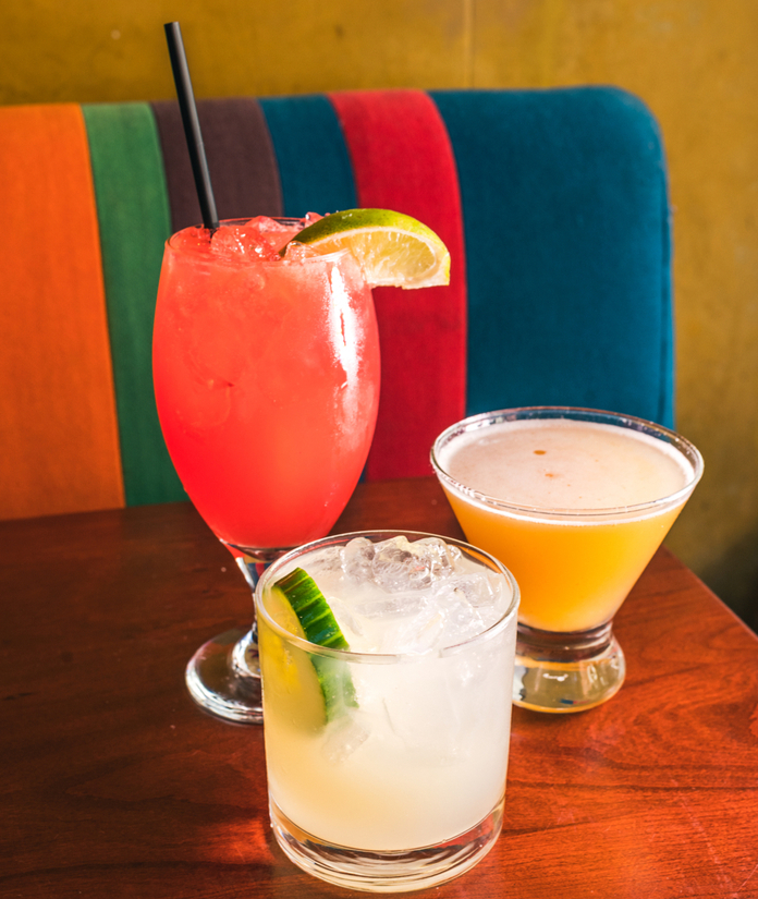 Neon sign for a restaurant with purple and pink lights, reading "Velz" with a rose design.